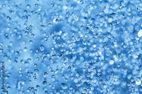 Blue water drops background in closeup.