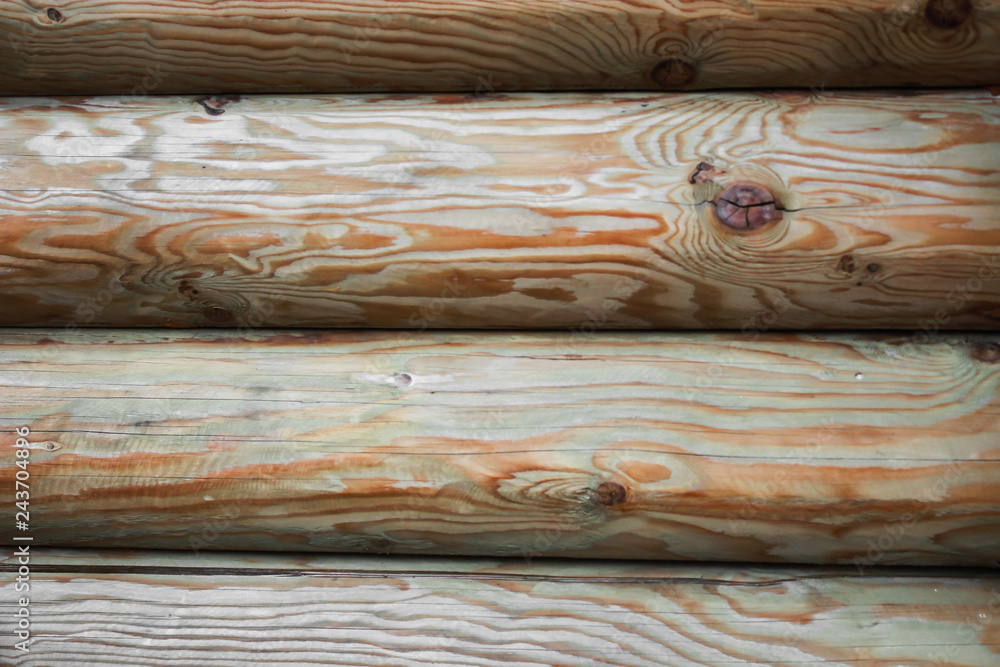 Beautiful Natural background Pattern of a Log Wall. Wooden Log Cabin Wall. Natural Colored Horizontal Background. Texture Detail Close Up. Log Cabin Or Barn Unpainted Debarked Wall. Beautiful Natural background Pattern of a Log Wall. Wooden Log Cabin Wall. Natural Colored Horizontal Background. Texture Detail Close Up. Log Cabin Or Barn Unpainted Debarked Wall.