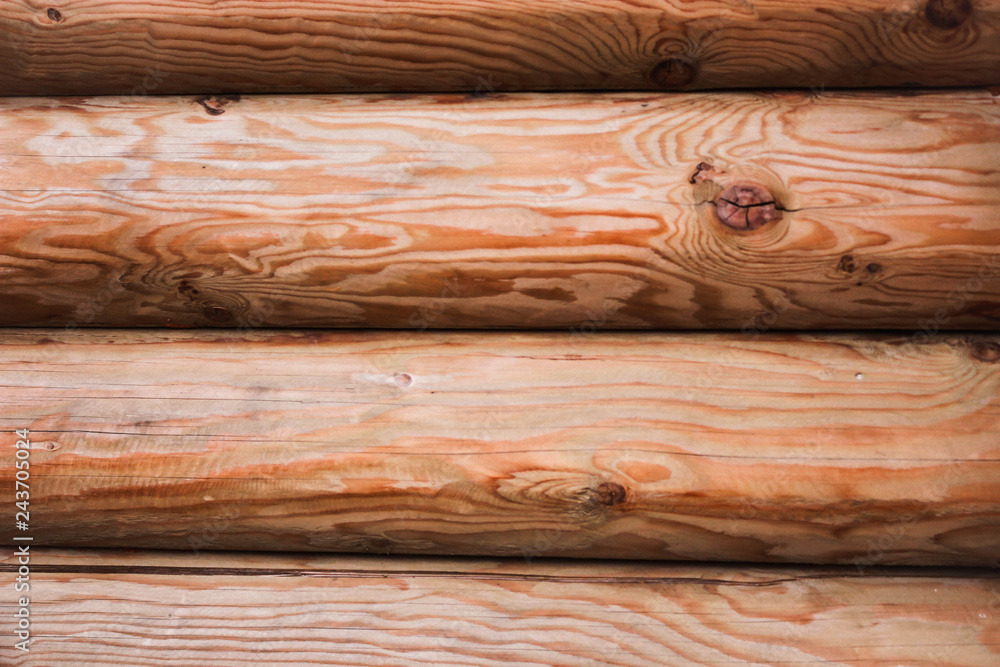Beautiful Natural background Pattern of a Log Wall. Wooden Log Cabin Wall. Natural Colored Horizontal Background. Texture Detail Close Up. Log Cabin Or Barn Unpainted Debarked Wall. Beautiful Natural background Pattern of a Log Wall. Wooden Log Cabin Wall. Natural Colored Horizontal Background. Texture Detail Close Up. Log Cabin Or Barn Unpainted Debarked Wall.