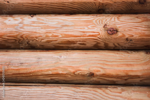 Beautiful Natural background Pattern of a Log Wall. Wooden Log Cabin Wall. Natural Colored Horizontal Background. Texture Detail Close Up. Log Cabin Or Barn Unpainted Debarked Wall.