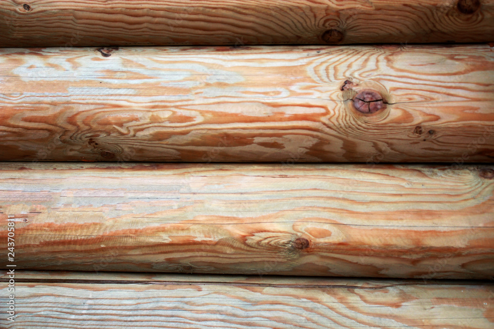 Beautiful Natural background Pattern of a Log Wall. Wooden Log Cabin Wall. Natural Colored Horizontal Background. Texture Detail Close Up. Log Cabin Or Barn Unpainted Debarked Wall. Beautiful Natural background Pattern of a Log Wall. Wooden Log Cabin Wall. Natural Colored Horizontal Background. Texture Detail Close Up. Log Cabin Or Barn Unpainted Debarked Wall.