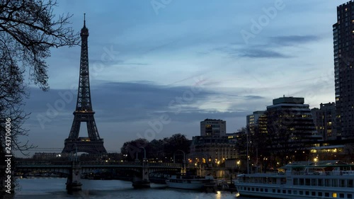 Night to Day timelapse of Eiffel tower in winter with train traffic (RER) on Pont Rouelle in foreground - Paris, France. photo