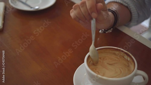 Two woman sharing coffee in cafe, close up shot on coffee cup