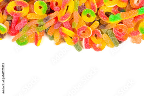 Frame of assorted gummy candies isolated on white. Top view. Space for text or design.