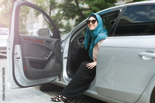 Muslim lady wearing hijab in her car. © Prostock-studio