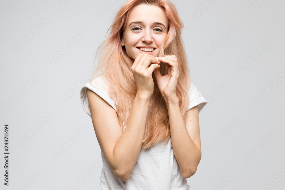 Cropped studio portrait of cute young inspired girl in white t-shirt looking at camera and smile, holds hand to face/good-looking, cheerful lady, satisfaction, people, beauty and lifestyle concept. Cropped studio portrait of cute young inspired girl in white t-shirt looking at camera and smile, holds hand to face/good-looking, cheerful lady, satisfaction, people, beauty and lifestyle concept.