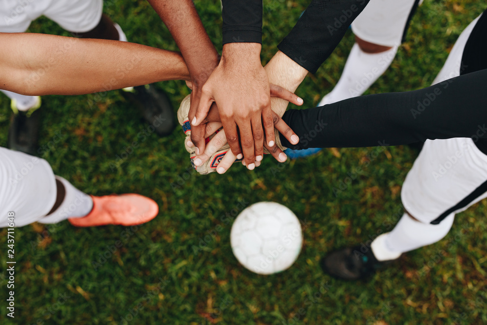 Close up of hands of players standing together in a huddle Close up of hands of players standing together in a huddle