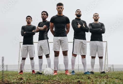 Footballers standing side by side on a soccer field © Jacob Lund