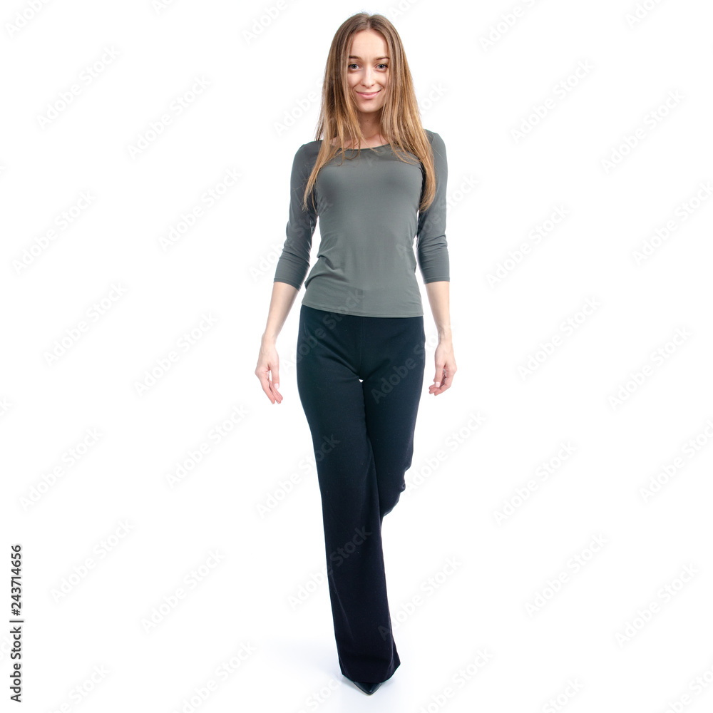 Woman in high heels shoes and black pants smile goes on white background isolation Woman in high heels shoes and black pants smile goes on white background isolation
