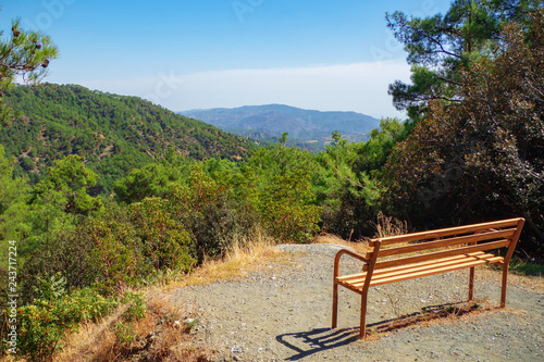 Picture of wooden bench on the top of the mountain with beautiful nature overview