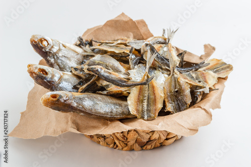 Assorted dried fish in a basket on craft paper