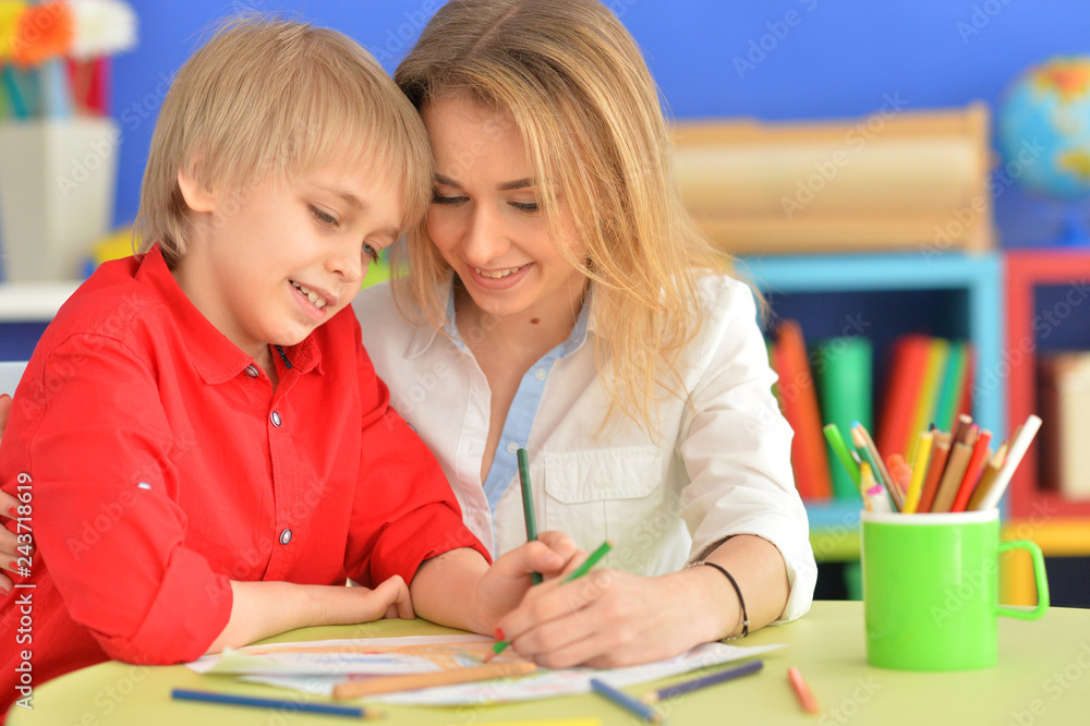 Close up view of smiling mother and son drawing Close up view of smiling mother and son drawing
