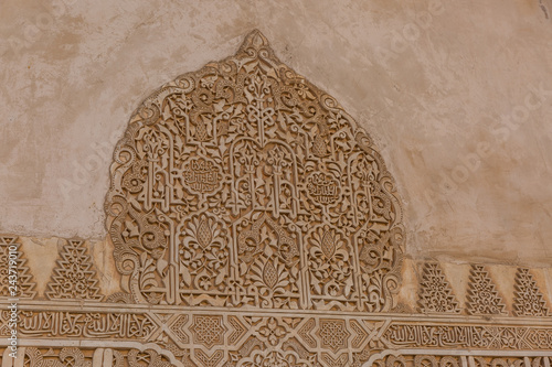 Architecture detail of Alhambra palace in Granada - South of Spain. 600 years old arabic characters