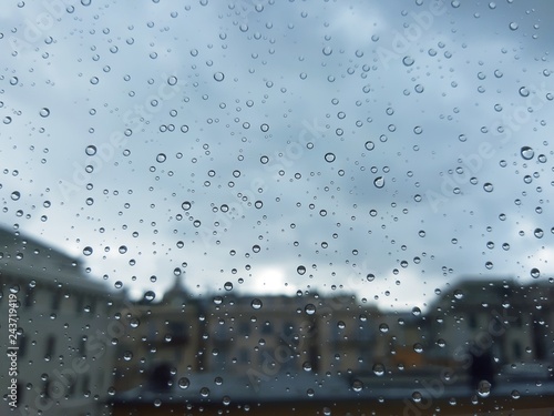Genova, Italy - 10/28/2018: An amazing photography of some waterdrops over the window after summer rain in the city