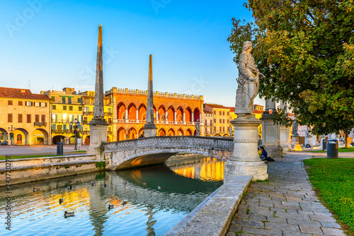 View of canal with statues on square Prato della Valle and Basilica Santa Giustina in Padova (Padua), Veneto, Italy