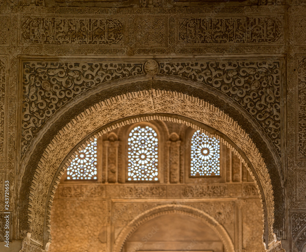 Ornate arched door with arabesque and Mocarabe designs in Comares Palace of Nasrid Alhambra Granada, Andalusia