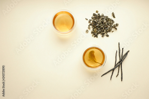 Green tea in two glass bowls, top view copy space