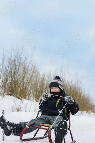 Happy small boy in winter snow covered courtyard © niko_cingaryuk
