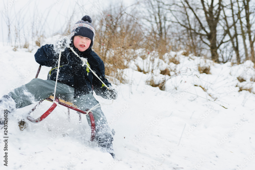 the child tries to stay in the sled so as not to fal the child tries to stay in the sled so as not to fal