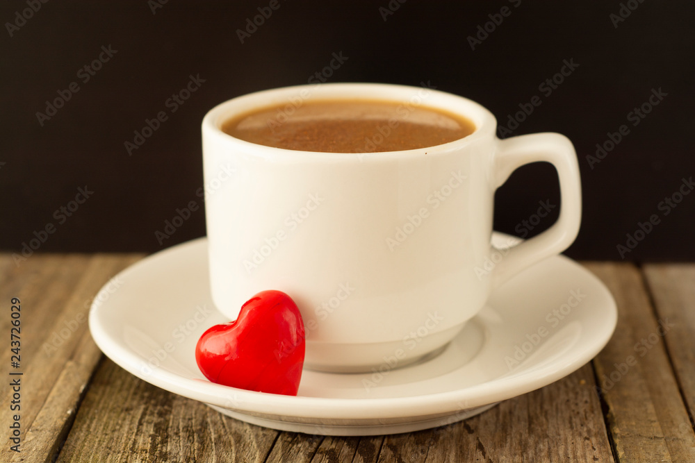 Coffee cup and red Heart on wooden background. Valentine's Day breakfast. Coffee cup and red Heart on wooden background. Valentine's Day breakfast.