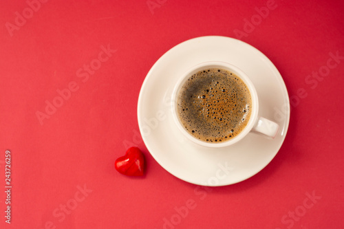 Cup of coffee isolated on red background. Flat lay. Web design, poster, invitation card. Valentine's Day concept.
