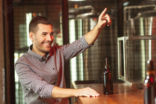 man ordering new glass of beer