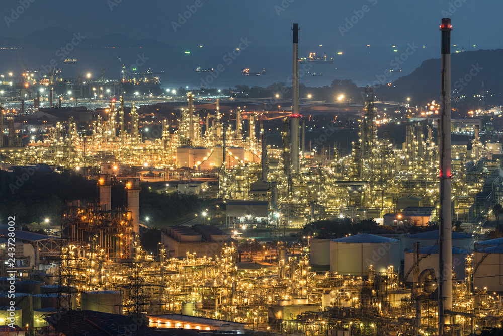 Aerial view oil storage tank with oil refinery background, Oil refinery plant at night.
