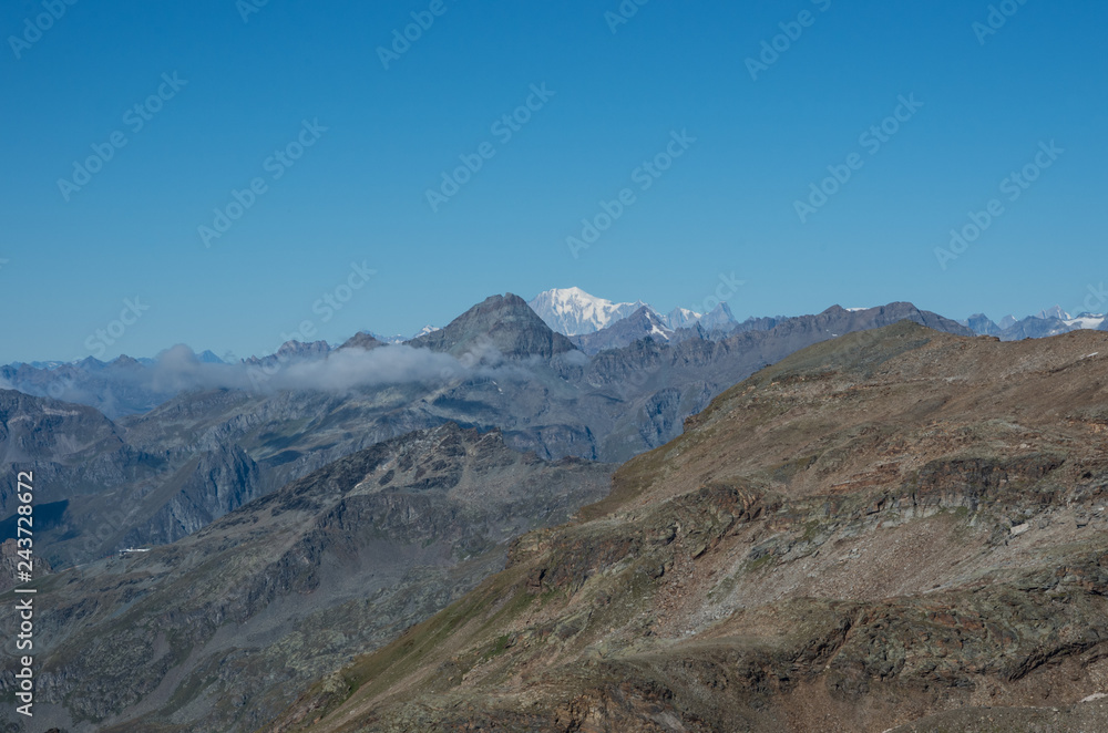 Mountain panorama of Aosta Valley from Monte Rosa massif near Punta Indren. Alagna Valsesia area, Italy