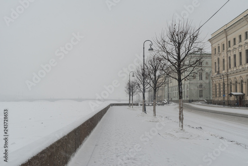 Palace Embankment and Hermitage Bridge in snowfall. Winter  in St. Petersburg, Russia photo