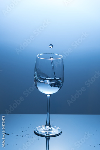 Water splash out of a wine glass.