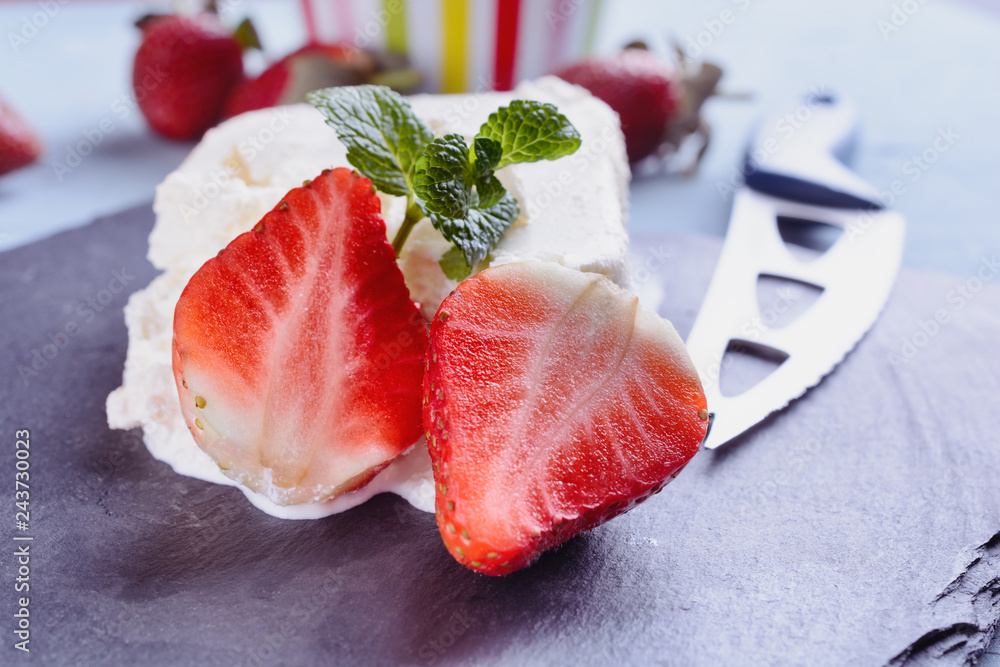 Delicious and fragrant strawberry slices next to riccotta cheese and mint leaf and knife Delicious and fragrant strawberry slices next to riccotta cheese and mint leaf and knife