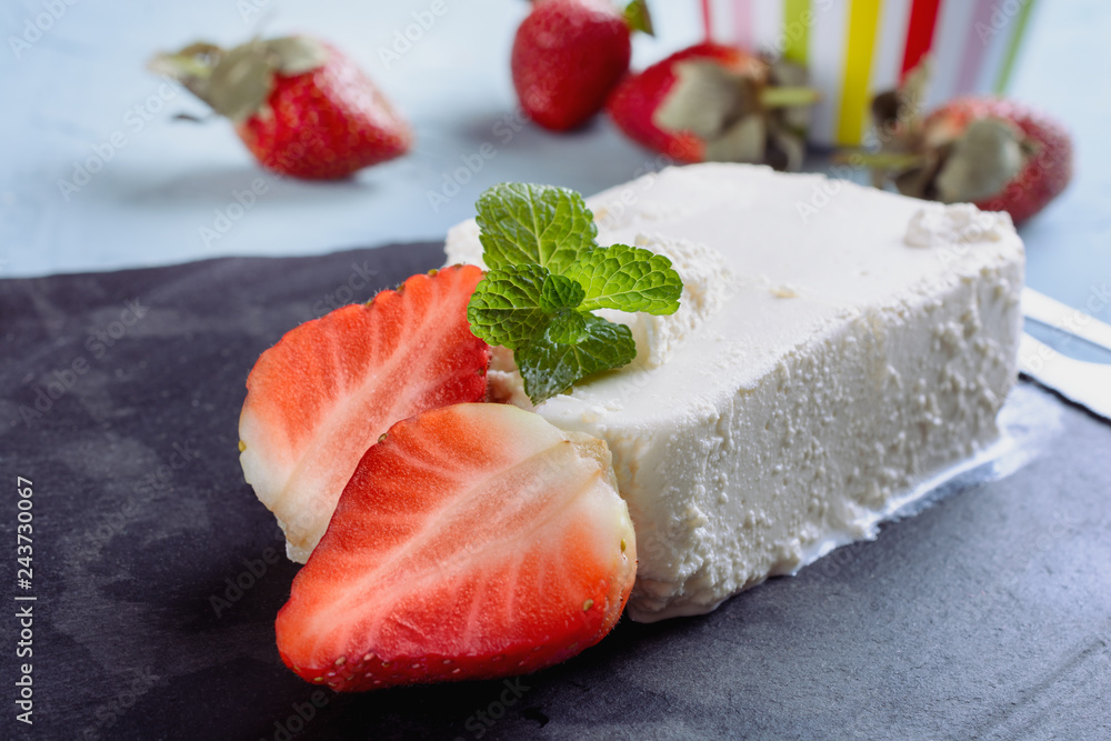 Delicious and fragrant strawberry slices next to riccotta cheese and mint leaf