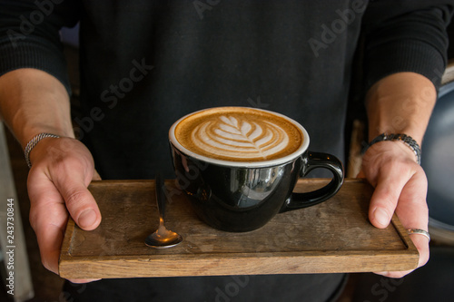 Cup of coffee  with latte art in the cafe 