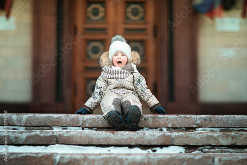 boy sitting on the stairs of the house