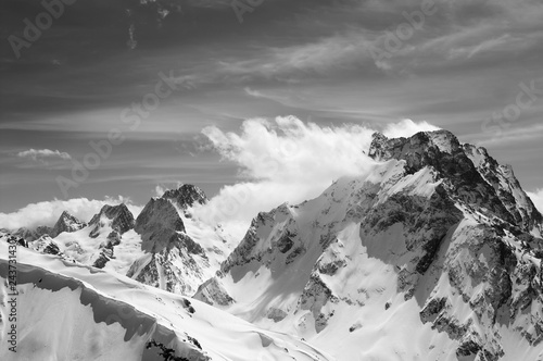 Black and white winter mountains with snow cornice