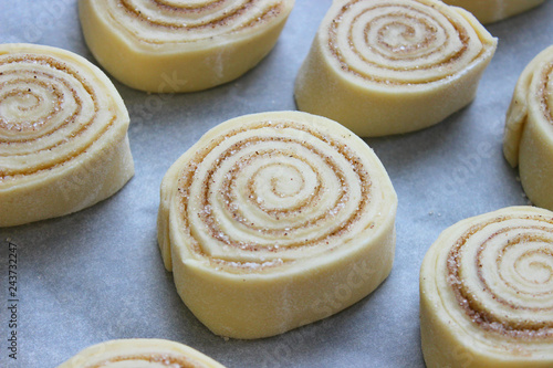 Beautiful fresh cinnamon rolls. The cooking process. Fresh fragrant pastries. Raw dough for buns.Close up.