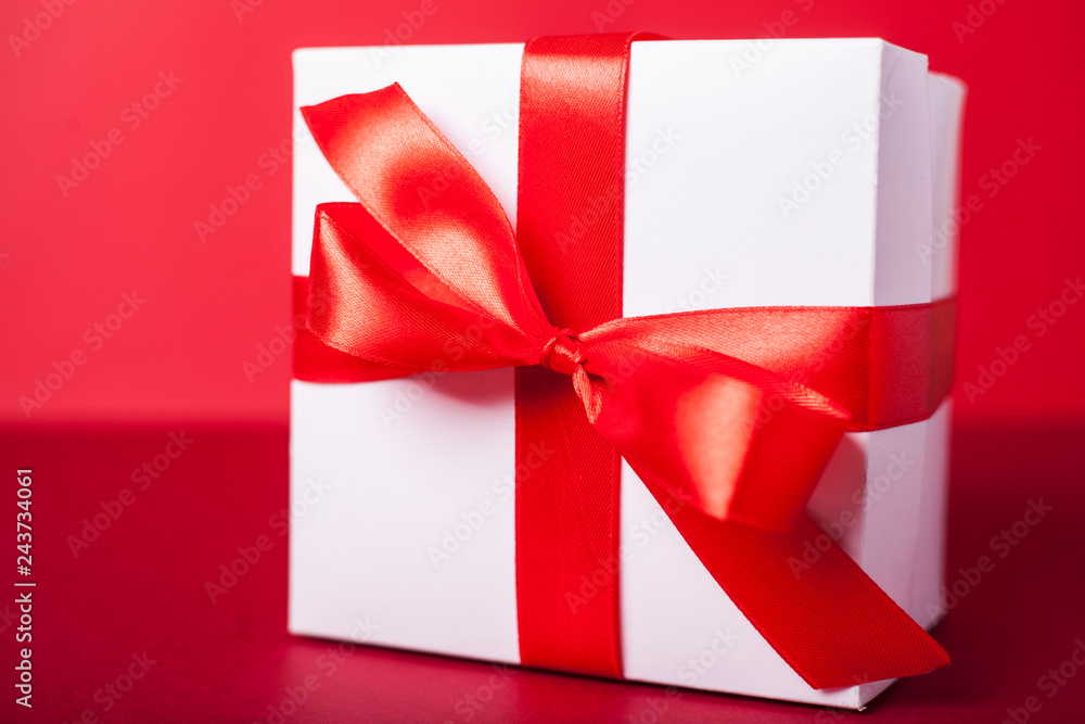 Gift box on red background. Valentine day, woman day gift. Red and white. ribbon, band. Gift box on red background. Valentine day, woman day gift. Red and white. ribbon, band.