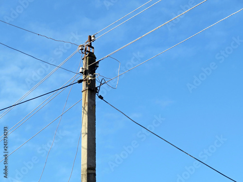 Wallpaper Mural Old power line post with electrical wires and capacitors isolated on blue sky background. Electricity transmission line, power supply Torontodigital.ca