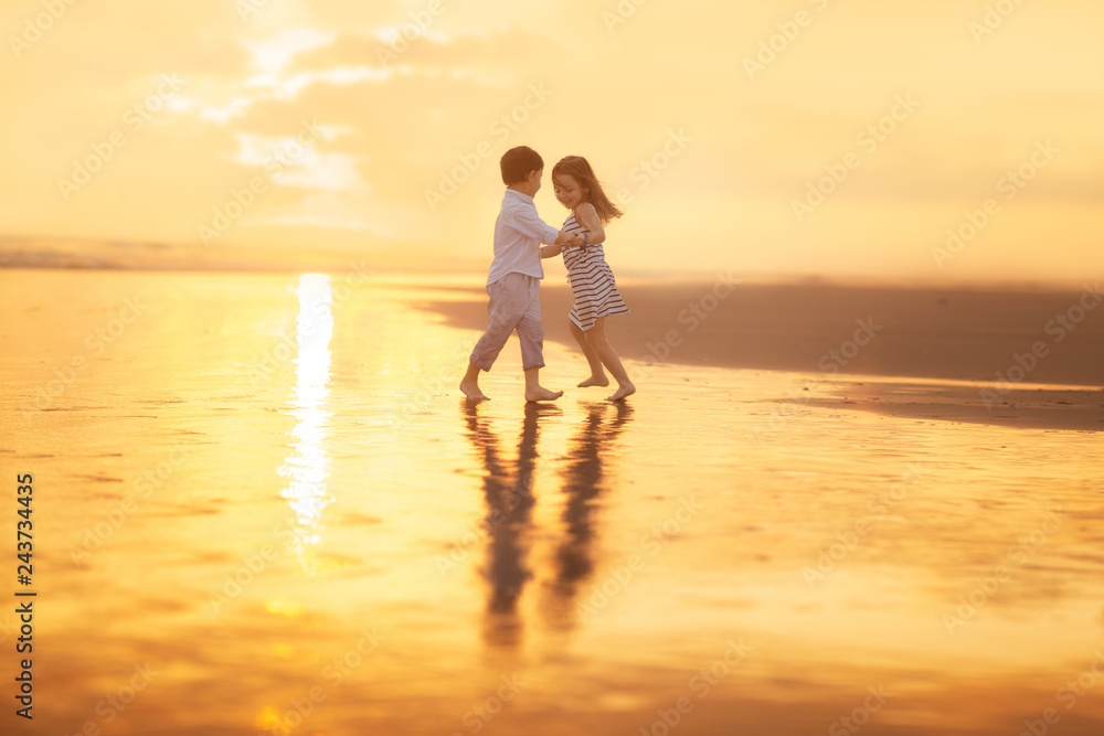 girl and boy dancing on the beach