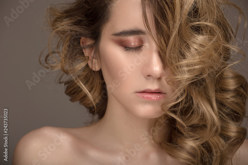 Closeup fashion woman portrait. Makeup and hairstyle. Curly hair and eyes closed