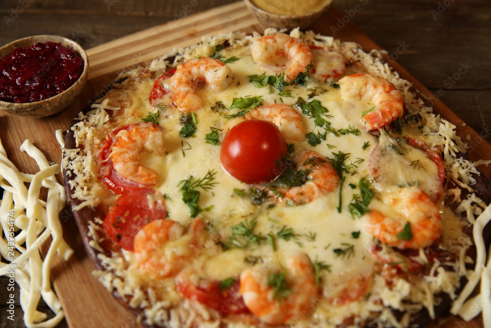 seafood pizza with shrimp and cheese on the wooden table seafood pizza with shrimp and cheese on the wooden table