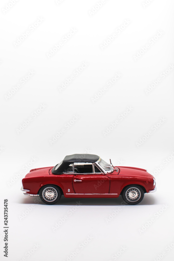 Miniature antique vintage model car isolated on a white background
