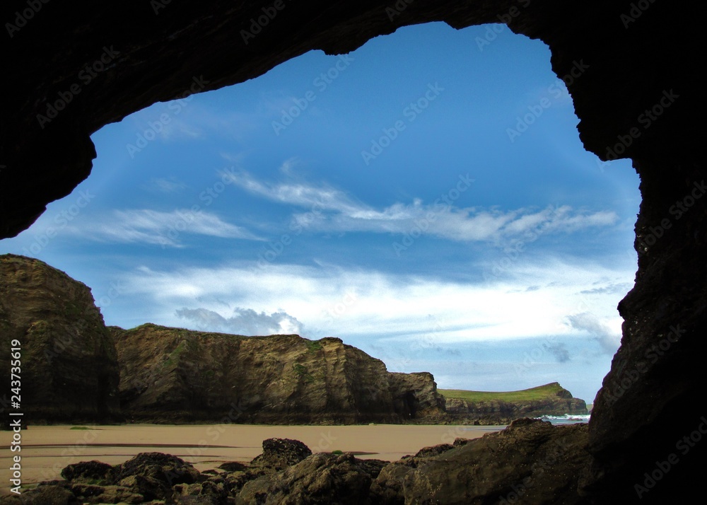 Whipisderry Beach Cave looking at Porth Island, Newquay, Cornwall, England