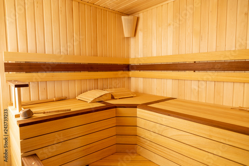 Traditional wooden sauna. Classic interior. Empty seats, bucket lies.