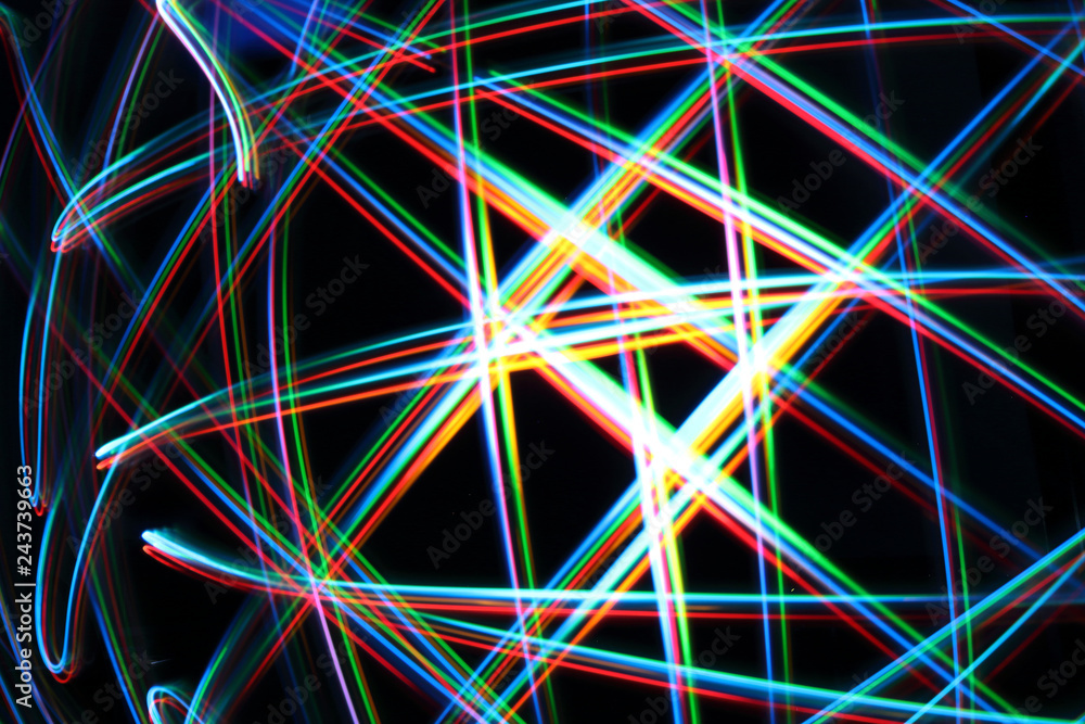 A colorful and glowing light painting abstract image with red, green, blue and yellow blurry lines over a black background, creating a net A colorful and glowing light painting abstract image with red, green, blue and yellow blurry lines over a black background, creating a net