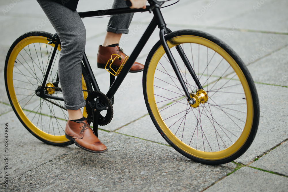Cropped picture of handsome young man with bicycle walking outdoors Cropped picture of handsome young man with bicycle walking outdoors