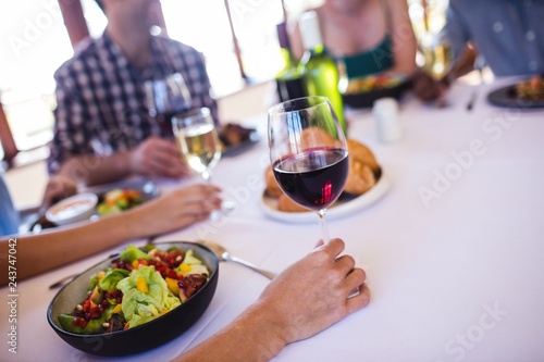 Woman holding wine glass in restaurant