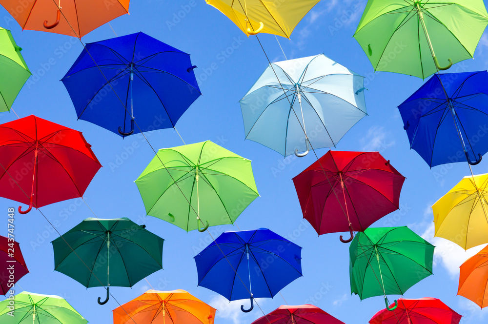 umbrellas of different colors soar in the summer sky umbrellas of different colors soar in the summer sky