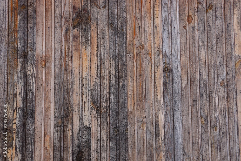 gray brown wooden texture from a row of planks in a fence wall