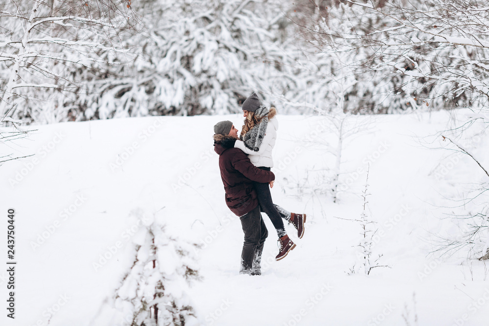 Young couple in love outdoor snowy winter